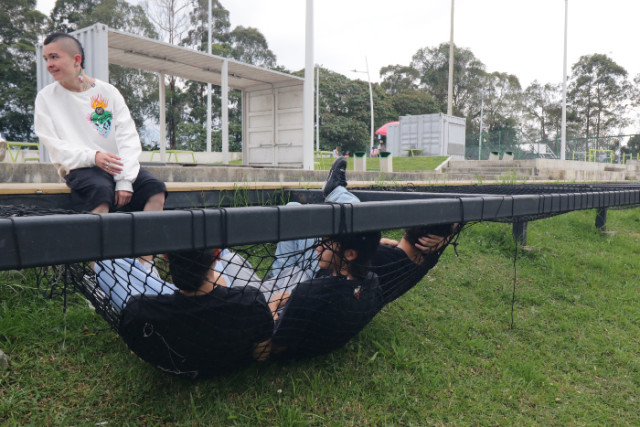 Las mallas al estilo glamping están descolgadas. Las personas al sentarse en ellas quedan en el suelo.