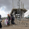 Mujeres palestinas desplazadas internamente cargan sus pertenencias tras una orden de evacuación emitida por el ejército israelí, en Rafah, sur de la Franja de Gaza, este lunes.