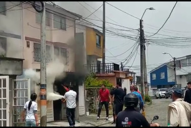 Los vecinos acudieron rápidamente a la casa incendiada para tratar de extinguir el fuego.