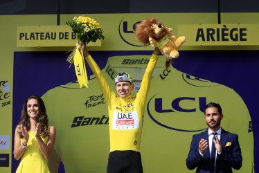 El ciclista esloveno Tadej Pogacar del UAE Team Emirates celebra con el maillot amarillo de líder general en el podio tras ganar la 15.ª etapa del Tour de Francia 2024.